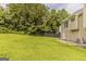 Well-maintained backyard with lush green grass and partial privacy fence at 1006 Eagle Vw, Lawrenceville, GA 30044