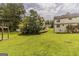 View of the grassy backyard, deck, and neighboring houses at 1006 Eagle Vw, Lawrenceville, GA 30044