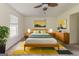 Comfortable bedroom with stylish decor, ceiling fan, and plenty of natural light from the large window at 1006 Eagle Vw, Lawrenceville, GA 30044