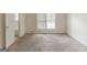 Bedroom showcasing neutral walls, carpet, a window, and an entrance to a bathroom at 1006 Eagle Vw, Lawrenceville, GA 30044