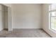 Bright empty bedroom featuring neutral walls, carpet, closet with door, and a side window at 1006 Eagle Vw, Lawrenceville, GA 30044