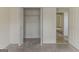 Spacious walk-in closet with carpet flooring and built-in shelving for ample storage at 1006 Eagle Vw, Lawrenceville, GA 30044