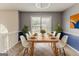 Bright dining room featuring modern table and chairs plus large sunlit window overlooking the yard at 1006 Eagle Vw, Lawrenceville, GA 30044