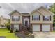 Charming two-story home featuring brick and siding exterior with a well-manicured front yard at 1006 Eagle Vw, Lawrenceville, GA 30044