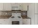 Kitchen appliances: white stove and microwave, complemented by countertops and cabinets at 1006 Eagle Vw, Lawrenceville, GA 30044