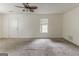 Large living room with neutral carpet and a door for easy access to outdoor spaces at 1006 Eagle Vw, Lawrenceville, GA 30044