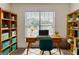 Bright home office with a wooden desk, ample storage with bookshelves and a cozy rug at 1006 Eagle Vw, Lawrenceville, GA 30044