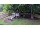 Backyard area featuring a fire pit, outdoor seating, a shed and a swing at 11940 Wexford Club Dr, Roswell, GA 30075