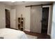 Bedroom with a rustic sliding door to the closet and wood laminate flooring at 11940 Wexford Club Dr, Roswell, GA 30075