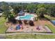 Aerial view of community pool, playground and clubhouse in a beautifully maintained, landscaped neighborhood at 11940 Wexford Club Dr, Roswell, GA 30075