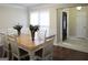 Dining room featuring a wooden table, seating for six, and a view into the entryway at 11940 Wexford Club Dr, Roswell, GA 30075