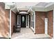 Charming brick home exterior showcasing a welcome sign and covered porch, highlighting curb appeal at 11940 Wexford Club Dr, Roswell, GA 30075