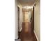 Hallway with wood floors, doors, and a sliding barn door at 11940 Wexford Club Dr, Roswell, GA 30075