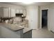Bright kitchen with white cabinets, tile backsplash, and modern appliances at 11940 Wexford Club Dr, Roswell, GA 30075