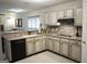 Well-lit kitchen features white cabinets, tile backsplash, and modern appliances at 11940 Wexford Club Dr, Roswell, GA 30075