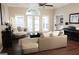 Inviting living room with hardwood floors, neutral colors, and French doors to the backyard at 11940 Wexford Club Dr, Roswell, GA 30075