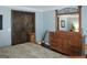 Stylish bedroom features wooden barn doors, hardwood flooring and a large wooden dresser at 11940 Wexford Club Dr, Roswell, GA 30075
