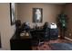 Cozy home office with black desk, chair and wood laminate flooring at 11940 Wexford Club Dr, Roswell, GA 30075