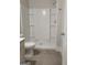 Bathroom featuring a white walk-in shower with built-in shelving and gray floor tiles at 2424 Saint Andrews Rdg, College Park, GA 30337