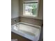 Bathroom featuring a soaking tub and a large window at 2424 Saint Andrews Rdg, College Park, GA 30337