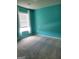 Bedroom with blue walls, white trim, neutral carpet, and window at 2424 Saint Andrews Rdg, College Park, GA 30337