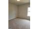Empty bedroom with neutral walls and carpet and window at 2424 Saint Andrews Rdg, College Park, GA 30337