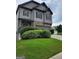 This home has a beautiful stone facade, gray siding, two car garage, and green lawn at 2424 Saint Andrews Rdg, College Park, GA 30337