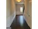 Inviting hallway featuring wainscoting, hardwood floors, and a staircase at 2424 Saint Andrews Rdg, College Park, GA 30337