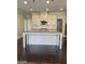 This is a modern kitchen featuring granite countertops, an island with seating, and sleek cabinetry at 2424 Saint Andrews Rdg, College Park, GA 30337