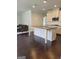 Modern kitchen with granite countertops, island seating, stainless appliances, and hardwood floors at 2424 Saint Andrews Rdg, College Park, GA 30337