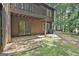 Backyard view featuring a deck, sliding glass doors, and natural surroundings with mature trees at 36 Cobblestone Crk, Peachtree City, GA 30269