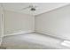 Spacious carpeted bedroom features a ceiling fan and ample natural light, creating a comfortable and inviting atmosphere at 36 Cobblestone Crk, Peachtree City, GA 30269