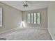 Bright bedroom with carpet, ceiling fan, and two windows, creates a relaxing and welcoming space at 36 Cobblestone Crk, Peachtree City, GA 30269