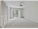 Bright bedroom with carpet, sliding glass door to balcony, ceiling fan and closet, offers plenty of natural light at 36 Cobblestone Crk, Peachtree City, GA 30269