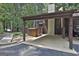Attached carport featuring a brown painted wooden exterior and concrete floor providing covered parking at 36 Cobblestone Crk, Peachtree City, GA 30269