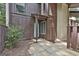 Exterior of entrance with stone pathway, brown siding, and a light blue-trimmed front door at 36 Cobblestone Crk, Peachtree City, GA 30269