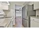 Well-maintained kitchen featuring white cabinets and stainless-steel refrigerator at 36 Cobblestone Crk, Peachtree City, GA 30269