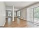 Open living room featuring wood floors, natural light, and sliding door at 36 Cobblestone Crk, Peachtree City, GA 30269