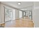 Living room with wood floors, neutral colors, and mirrored wall at 36 Cobblestone Crk, Peachtree City, GA 30269