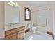 Bathroom featuring white tile, a toilet, and vanity sink adjacent to a tub/shower combo at 936 Bo Bo Banks Rd, Grantville, GA 30220