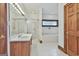 Bathroom featuring a vanity, glass-enclosed shower, and large bathtub at 936 Bo Bo Banks Rd, Grantville, GA 30220