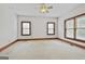Bedroom featuring wall-to-wall carpeting, a ceiling fan, and three windows at 936 Bo Bo Banks Rd, Grantville, GA 30220