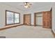 Large bedroom with a built-in bookcase and a wooden door to a walk-in closet at 936 Bo Bo Banks Rd, Grantville, GA 30220