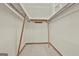 Empty walk-in closet with carpet, white walls, wooden supports and shelves at 936 Bo Bo Banks Rd, Grantville, GA 30220