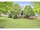 Charming home featuring a quaint front porch framed by lush greenery and mature trees at 936 Bo Bo Banks Rd, Grantville, GA 30220