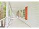 Spacious front porch with classic white columns and bright red window shutters at 936 Bo Bo Banks Rd, Grantville, GA 30220