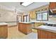 Kitchen features white countertops, wood cabinets, an island, and hardwood floors at 936 Bo Bo Banks Rd, Grantville, GA 30220