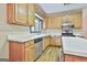 Kitchen showcasing wood cabinets, white countertops, and stainless steel appliances at 936 Bo Bo Banks Rd, Grantville, GA 30220