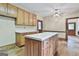 Bright kitchen with wooden cabinets, island, and natural light streaming through the window at 936 Bo Bo Banks Rd, Grantville, GA 30220