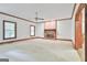 Spacious living room with a brick fireplace and large windows for ample natural light at 936 Bo Bo Banks Rd, Grantville, GA 30220